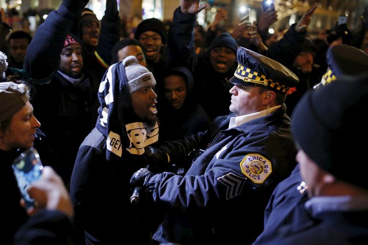 Demonstrators confront cops during a protest over the fatal shooting of Laquan McDonald in Chicago. Emanuel has struggled to explain the concealment of a video of the shooting.