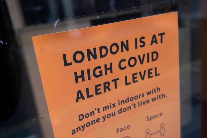 London is at high Covid alert level sign in a shop window 
