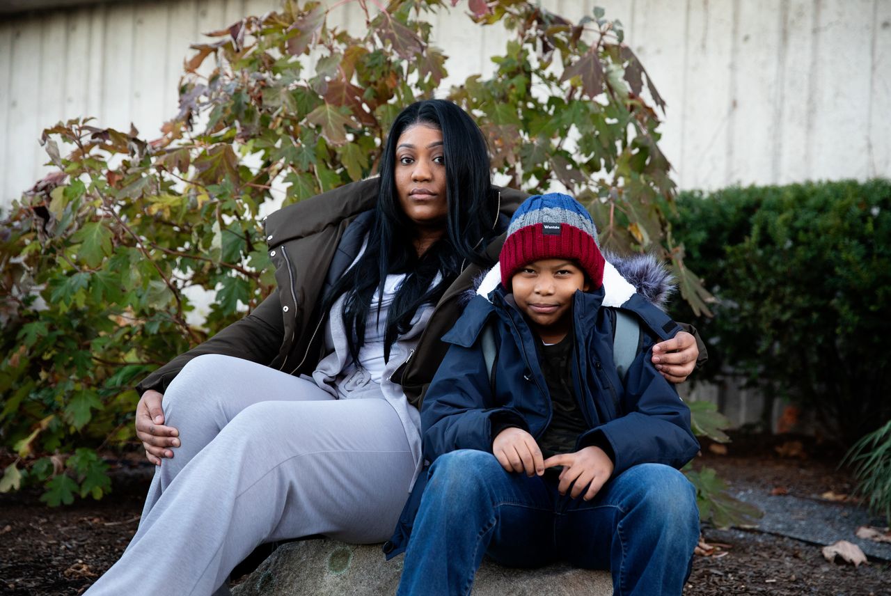 Amina Scott and her son, Yasin, 8, pose for a portrait together on Nov. 24 in Boston.