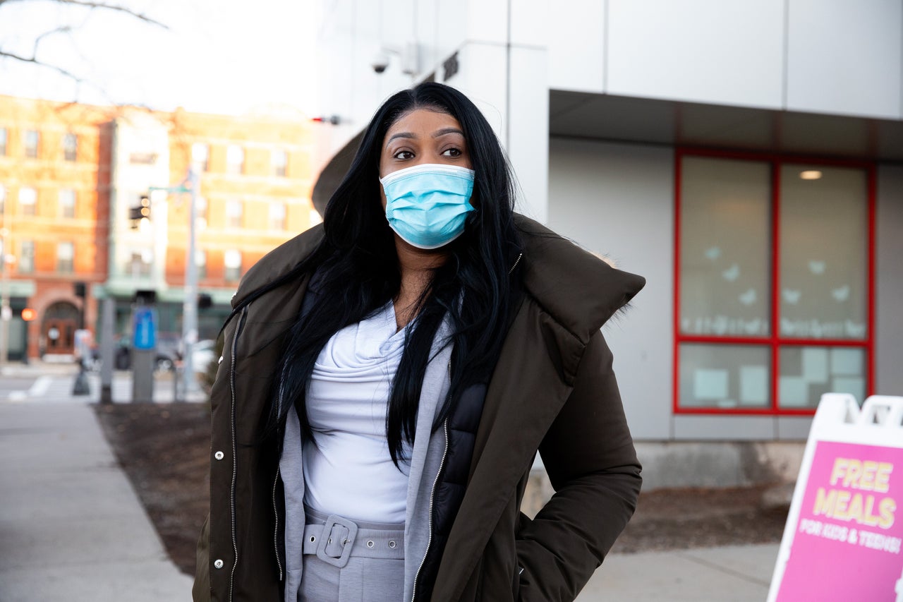 Scott waits for her son's bus to arrive outside of the Roxbury YMCA on Nov. 24.