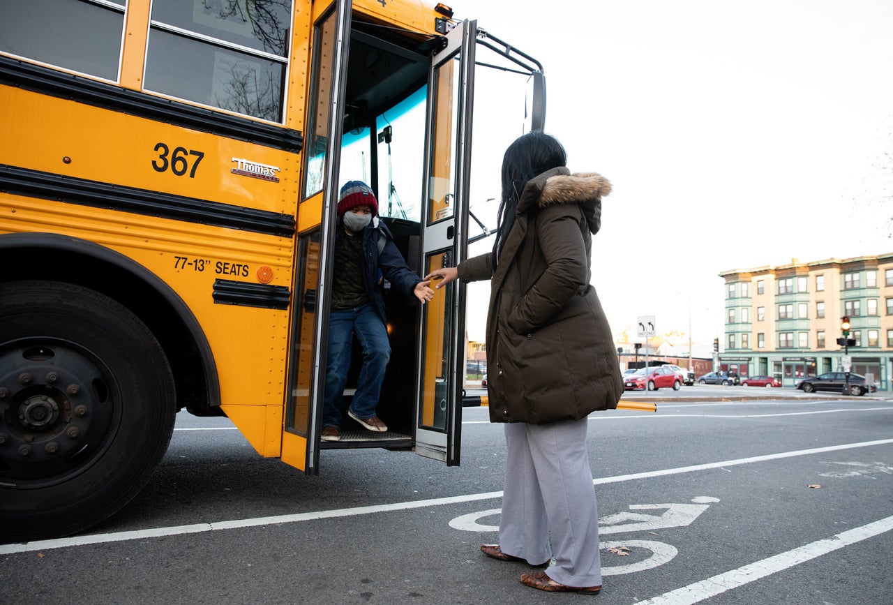 Scott greets Yasin as he gets off the bus after school on Nov. 24.