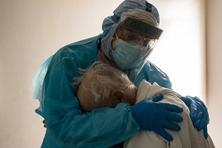 Dr. Joseph Varon hugs and comforts a patient in the COVID-19 intensive care unit on Thanksgiving day at the United Memorial Medical Center in Houston, Texas.