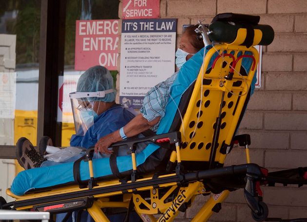 A patient is taken from an ambulance into a hospital in the Navajo Nation town of Tuba City during a...