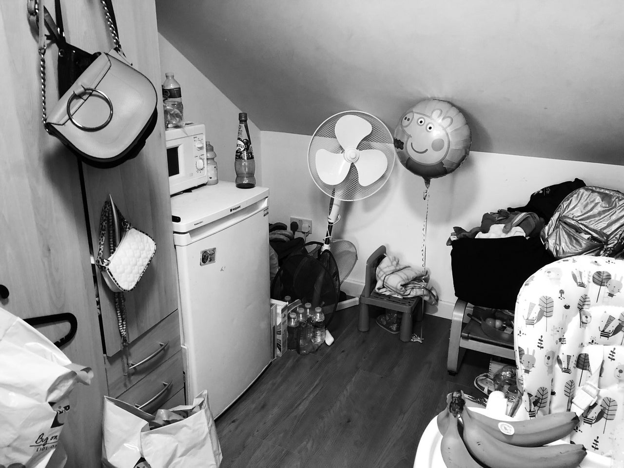 Children's belongings under the eaves of the loft room where Rafiat and her daughter live