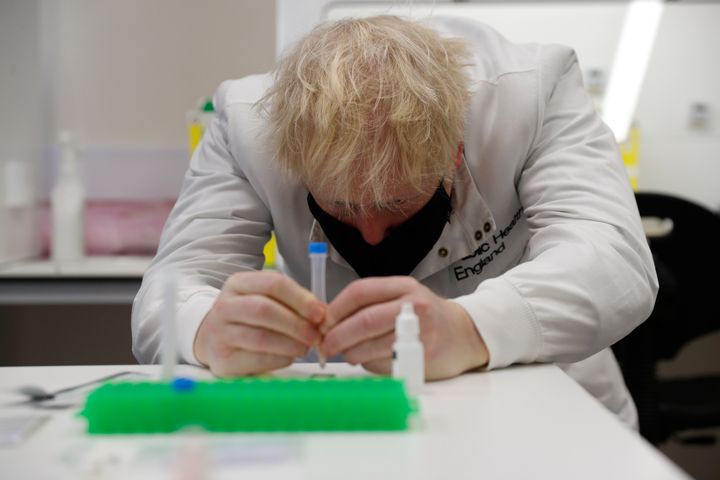 Boris Johnson looks at samples at the lateral flow testing lab at PHE Porton Down