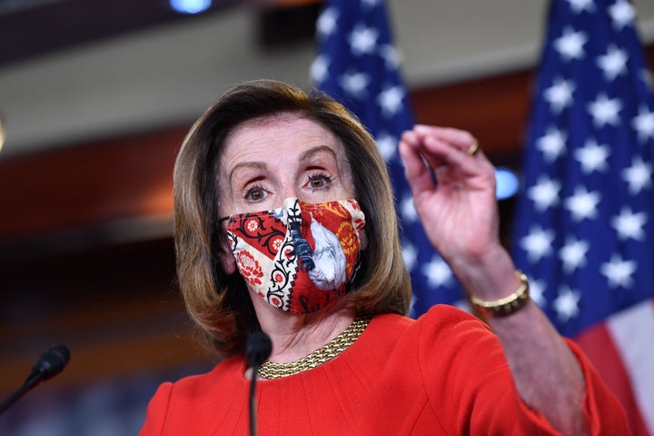 Speaker of the House Nancy Pelosi (D-Caif.) speaks during her weekly press briefing at Capitol Hill on Friday. She said "there is momentum” for passing a coronavirus relief bill. 