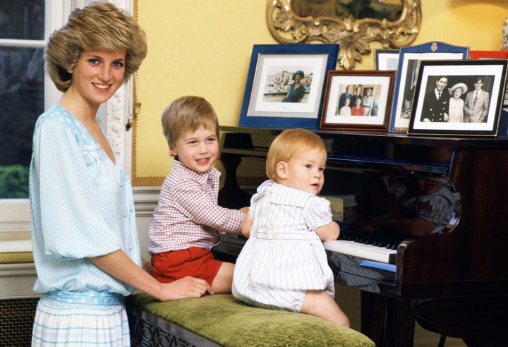 The Princess of Wales with her sons, William and Harry, at the piano in Kensington Palace. 