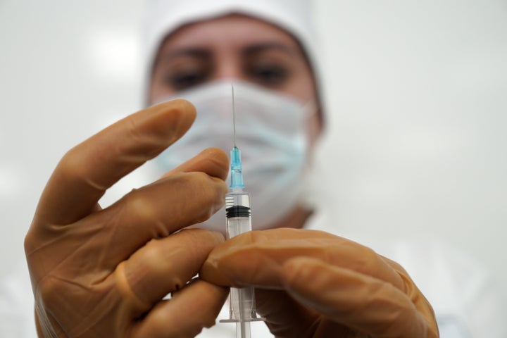 KALININGRAD, RUSSIA - DECEMBER 4, 2020: A nurse prepares to give a serviceman of the Russian Navy's Baltic Fleet the Russian Sputnik V vaccine during COVID-19 vaccination. Vitaly Nevar/TASS (Photo by Vitaly Nevar\TASS via Getty Images)