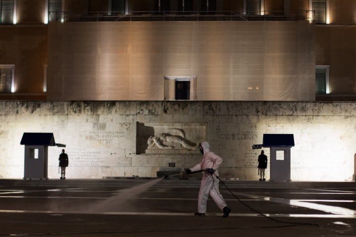 Municipal service cleans the Greek Parliament, in Athens, Greece, on November 13, 2020 amid the Covid-19 nightly curfew. (Photo by Konstantinos Zilos/NurPhoto via Getty Images)