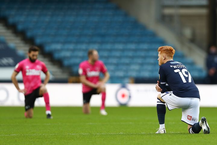 Ryan Woods of Millwall takes the knee during the Sky Bet Championship match between Millwall and Derby County at The Den on Saturday.