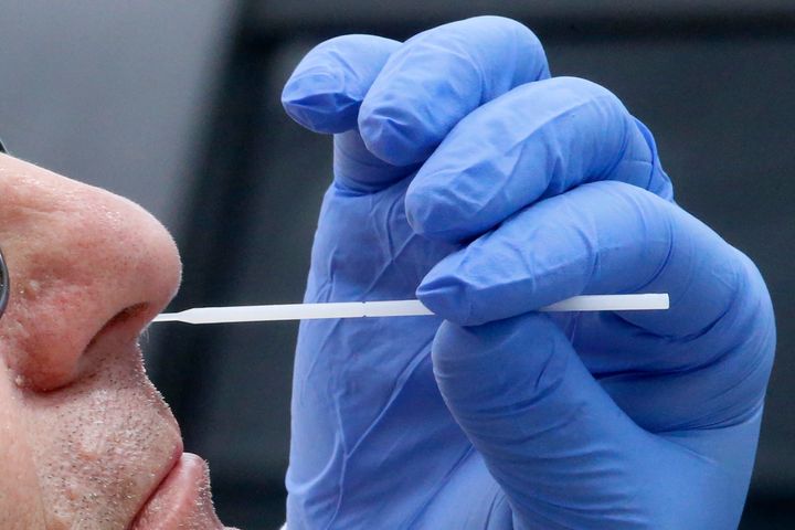 A nurse uses a swab to perform a coronavirus test in Salt Lake City. The FBI in New Jersey is asking anyone who received a COVID-19 test at a lab along the Jersey Shore to get retested as soon as possible. 