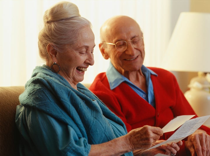 Elderly couple reading letter