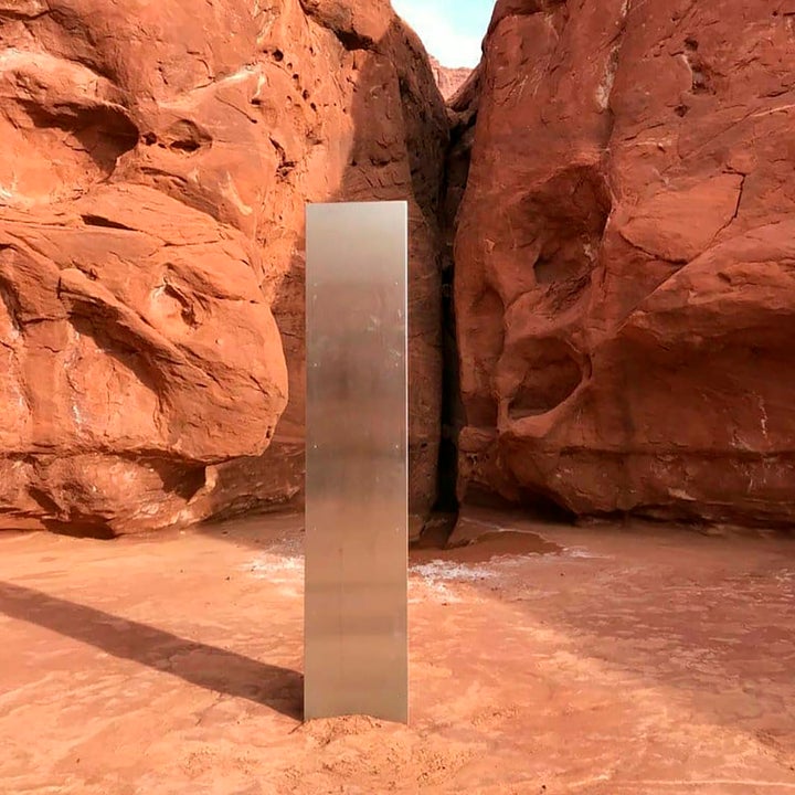 The first metal monolith installed in the ground in a remote area of red rock in Utah 