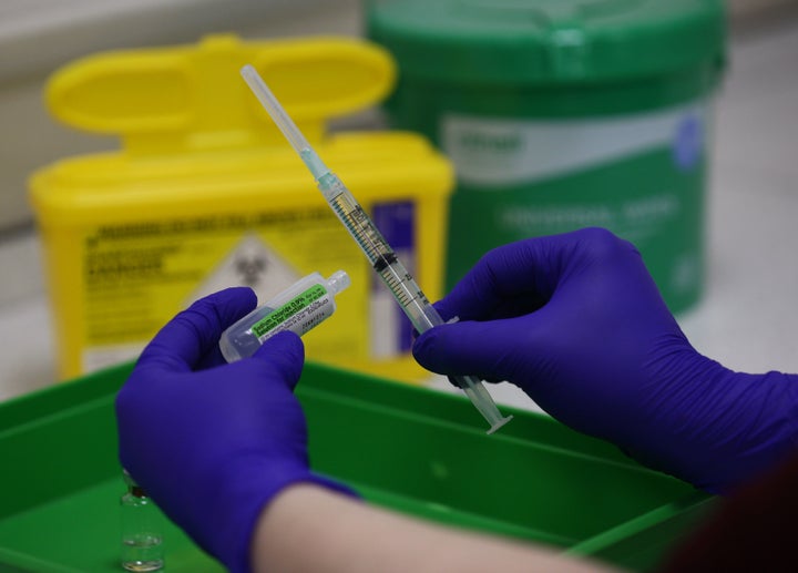 LONDON, ENGLAND - DECEMBER 05: An NHS pharmacy technician at the Royal Free Hospital, London, simulates the preparation of the Pfizer vaccine to support staff training ahead of the rollout, on December 5, 2020 in London, England. (Photo by Yui Mok - WPA Pool/Getty Images)