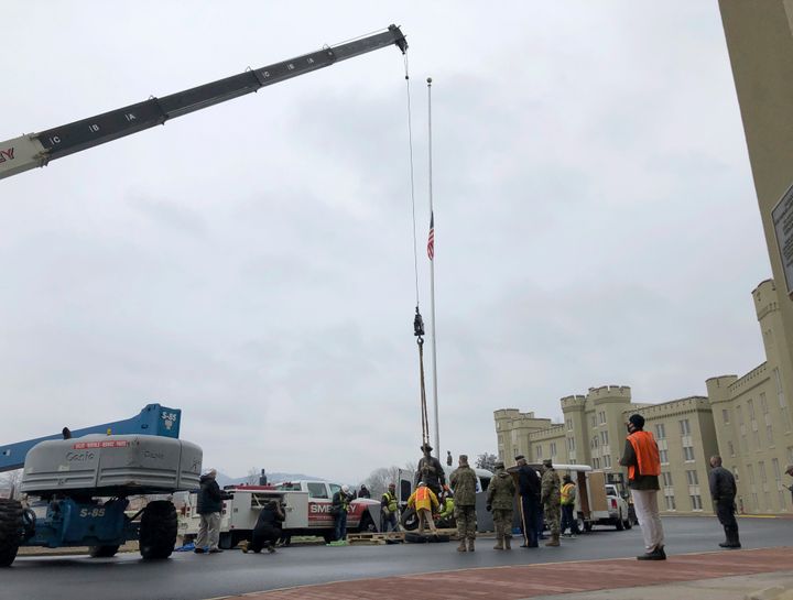 Crews lift a statue of Confederate Gen. Thomas "Stonewall" Jackson from its pedestal on the campus of the Virginia Military Institute on Monday in Lexington, Va.
