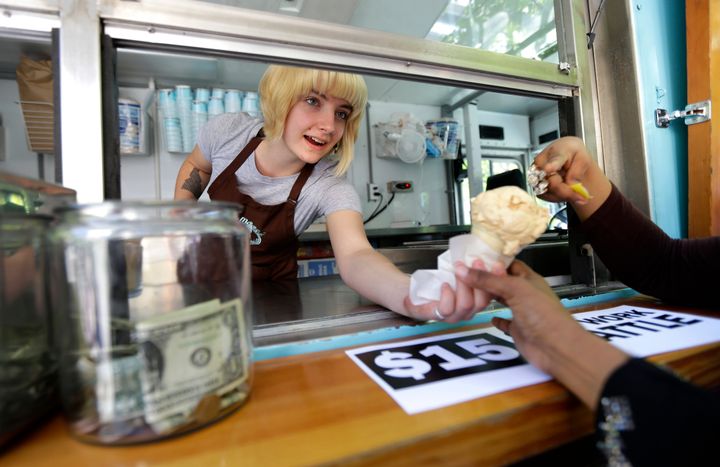 Caitlyn Faircloth, a worker with Molly Moon's Homemade Ice Cream, hands out free ice cream in 2014. Business across the company's nine scoop shops is down 40% in 2020.
