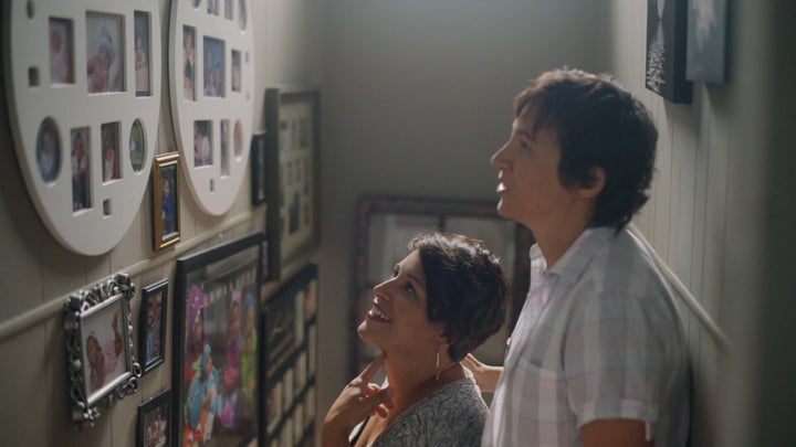 Ashley and Ellie look at pictures of their family.(Photograph: Courtesy of Pantene)