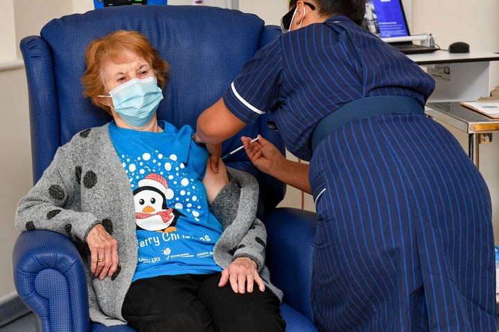 Margaret Keenan, 90, the first patient in the UK to receive the Pfizer-BioNTech COVID-19 vaccine, administered by nurse May Parsons at University Hospital, Coventry, England, Tuesday Dec. 8, 2020.