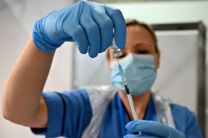 A nurse prepares a dose of the Pfizer-BioNTech Covid-19 vaccine on December 8, 2020 as Britain starts is biggest ever vaccination programm