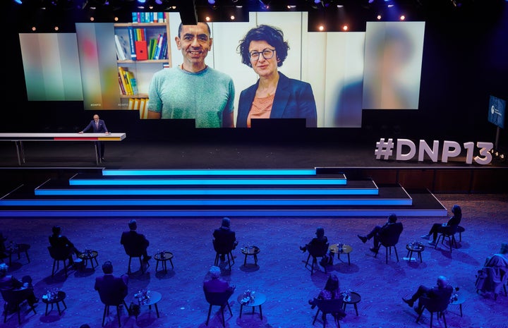 Özlem Tureci (l) and Ugur Sahin (r) shown on screen during an awards ceremony in early December.