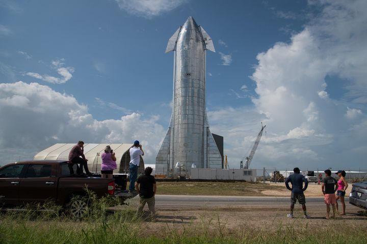 Space enthusiasts look at a prototype of SpaceX's Starship spacecraft at the company's Texas launch facility on September 28, 2019 in Boca Chica near Brownsville, Texas. (Photo by Loren Elliott/Getty Images)