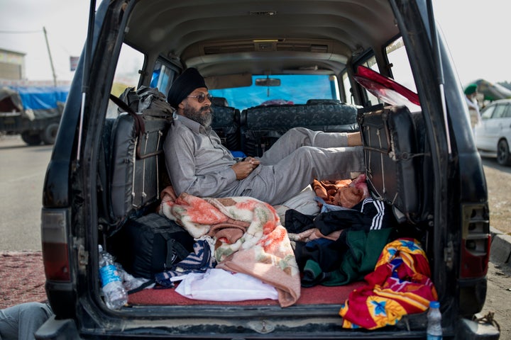 Savek Singh, 48, rests inside his vehicle parked on a highway as he joins a farmers protest at the Delhi-Haryana state border, India, on Dec. 1, 2020. 