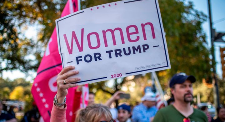 A woman holds a "Women For Trump" sign at a protest in Austin, Texas, on Nov. 7.