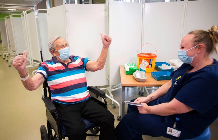 Henry (Jack) Vokes, 98, reacts receiving the Pfizer-BioNTech COVID-19 vaccine at Southmead Hospital, Bristol, England, Tuesday Dec. 8, 2020.