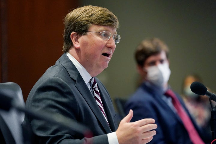 Gov. Reeves is seen explaining his rationale for not ordering a statewide mask mandate last month while seated next to S