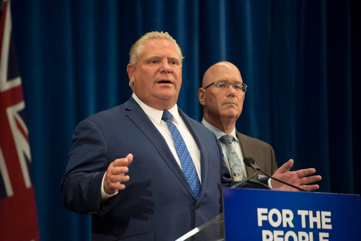 Ontario Premier Doug Ford speaks to reporters with Minister of Municipal Affairs and Housing Steve Clark in Toronto on Sept. 10, 2018. 