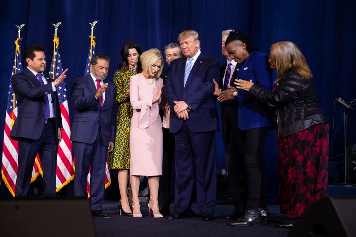 Faith leaders, including Maldonado (far left), pray over Trump during an "Evangelicals for Trump" coalition launch at King Jesus International Ministry on Jan. 3, 2020.