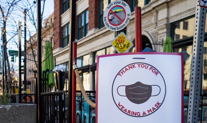 A sign encouraging customers to wear a mask at the entrance of a business in downtown Boise, Idaho, in November.