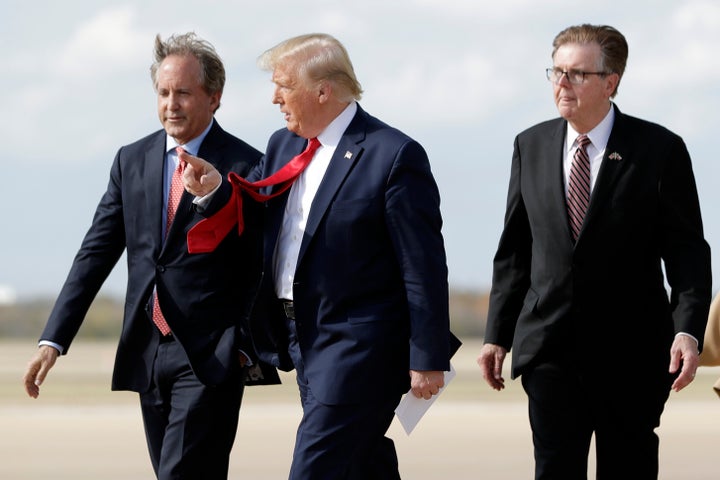 President Donald Trump walks with Texas Attorney General Ken Paxton (left) and Texas Lt. Gov. Dan Patrick (right) at Austin-Bergstrom International Airport in Austin in November 2019. (AP Photo/ Evan Vucci)