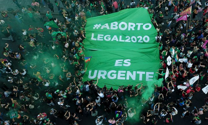 Abortion-rights activists in Argentina demonstrate in favor of decriminalizing abortion with a banner that reads in Spanish "Legal abortion 2020. It's urgent," in Buenos Aires on Nov. 18.