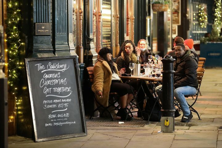 People drink outside a pub, amid the coronavirus on December 5