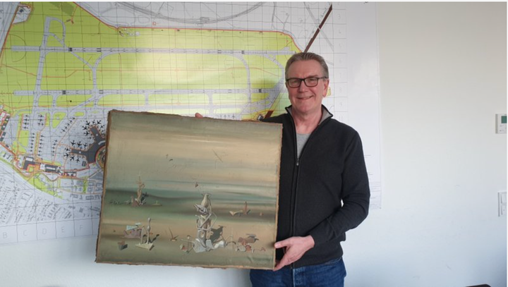 Chief Detective Michael Dietz of the Dussedorf Police Department holds a painting from French artist Yves Tanguy. A businessm