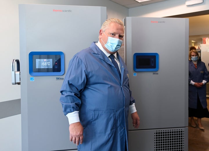 Ontario Premier Doug Ford looks at freezers ahead of COVID-19 vaccine distribution in Toronto on Dec. 8, 2020.