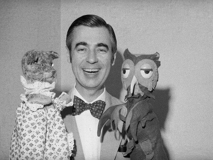 Fred Rogers, aka Mister Rogers, holds up two of his longtime neighbors, Henrietta Pussycat (left) and X the Owl.