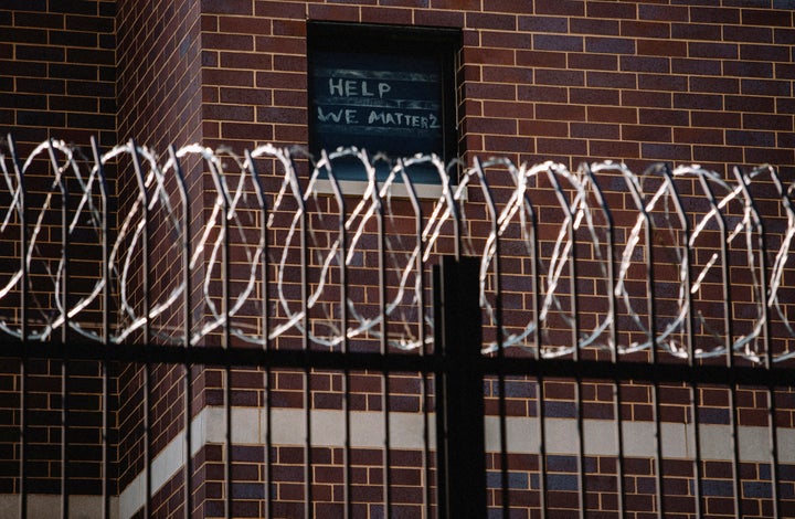 Prisoners in Chicago's Cook County Jail plead for help by posting a sign in window.