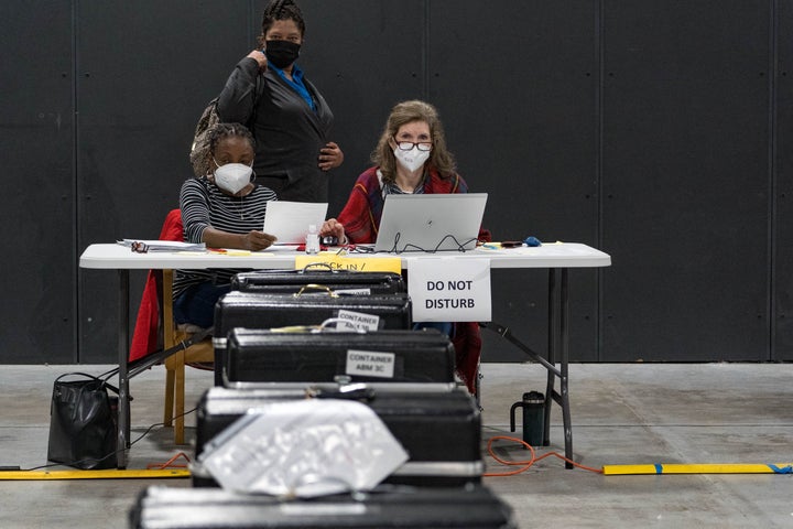 Gwinnett County election workers handle electronic ballots as part of the recount for the 2020 presidential election at the Beauty P. Baldwin Voter Registrations and Elections Building on Nov. 16, 2020 in Lawrenceville, Georgia. 