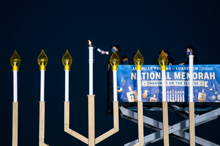 Rabbi Levi Shemtov, executive vice president of American Friends of Lubavitch, lights the National Menorah during a ceremony in President's Park just south of the White House on December 10, 2020 in Washington, DC.