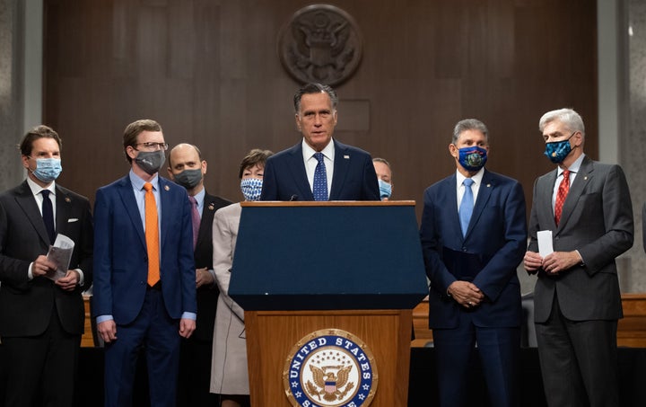 Sen. Mitt Romney (R-Utah), center, speaks alongside a group of Democrat and Republican members of Congress as they announce a