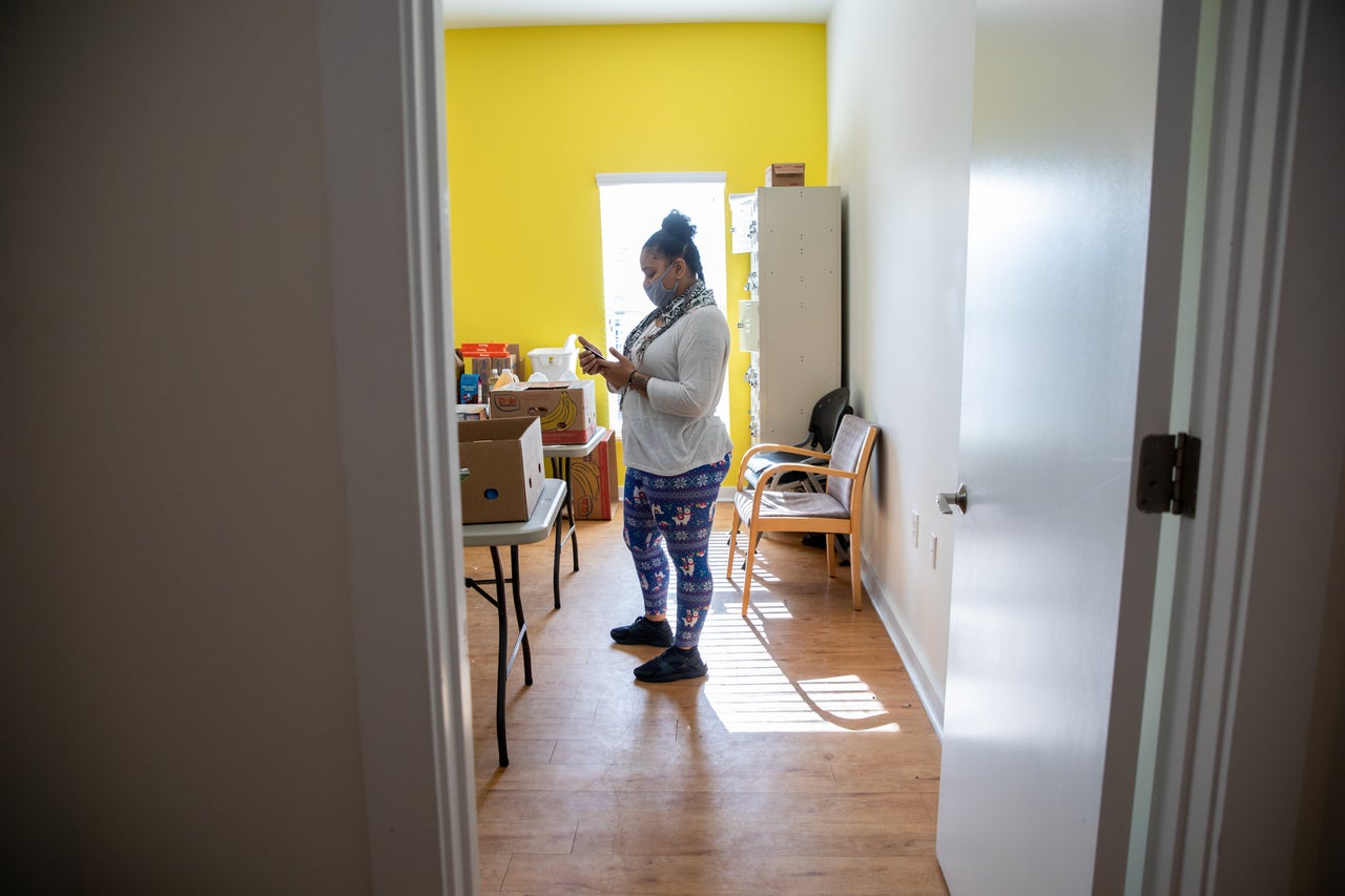 Nawaal Walker checks her phone while working her job at a mental health treatment center. 