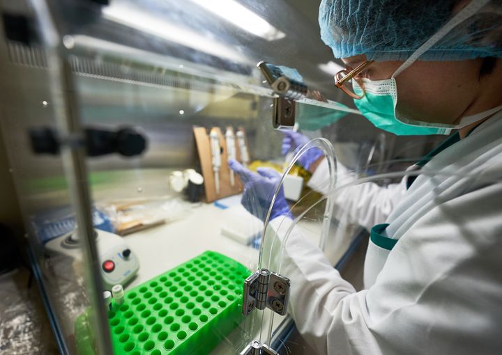 Researcher performing microbiology separator for PCR diagnosis test in pathology laboratory.