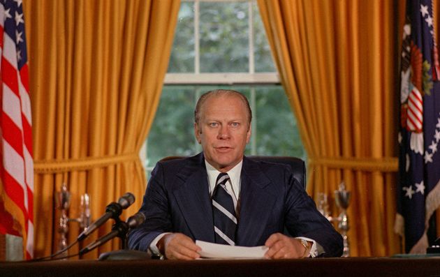 President Gerald Ford reads a proclamation in the White House on Sept. 8, 1974 granting former president Richard Nixon 