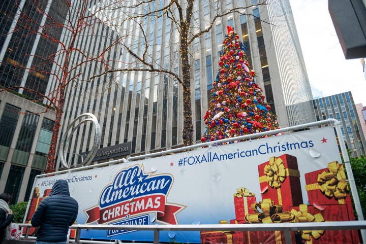 An "All American Christmas at Fox Square" sign near Christmas decorations in front of the News Corporation building in New Yo