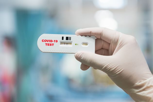 Doctor hand holding positive Coronavirus or Covid-19 rapid