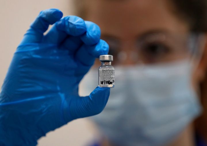 A nurse holds a vial of the Pfizer-BioNTech COVID-19 vaccine at Guy's Hospital in London on Tuesday.