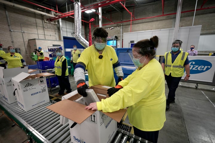 Boxes containing the Pfizer-BioNTech COVID-19 vaccine are prepared to be shipped at the Pfizer Global Supply Kalamazoo manufa