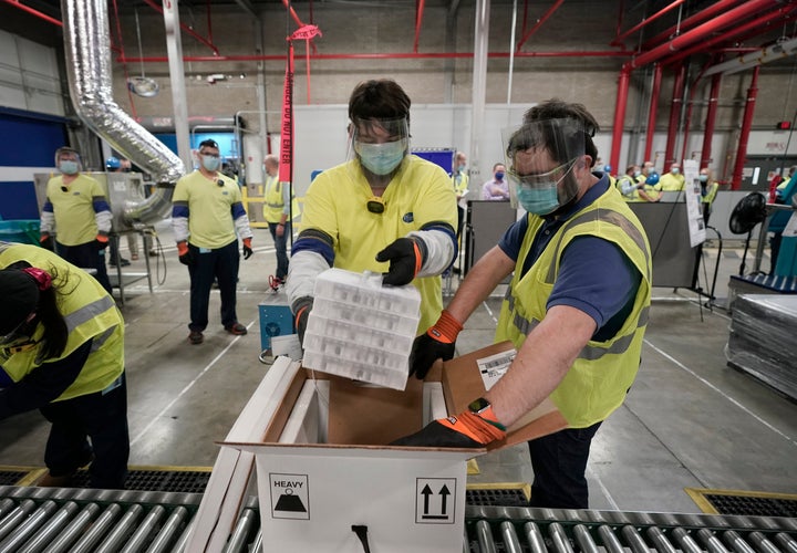 Boxes containing the Pfizer-BioNTech COVID-19 vaccine are prepared to be shipped at the Pfizer Global Supply Kalamazoo manufa